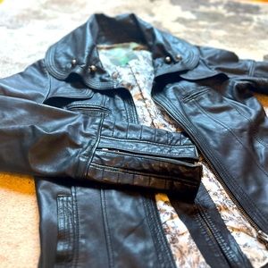 Leather jacket with unique detailing and fitted silhouette.